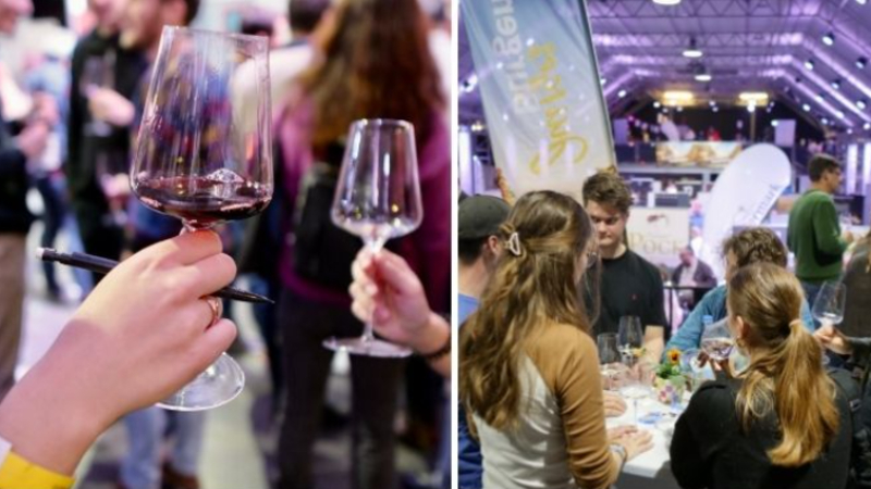 Close-up of hands holding wine glasses at a crowded wine-tasting event.