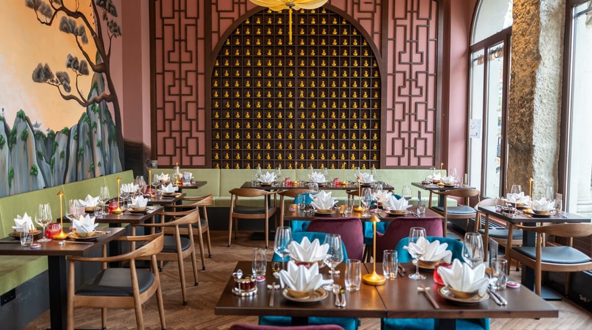 Gastraum des DOAN Restaurants in München-Sendling mit eingedeckten Tischen und Lotusblüten-Deckenleuchten