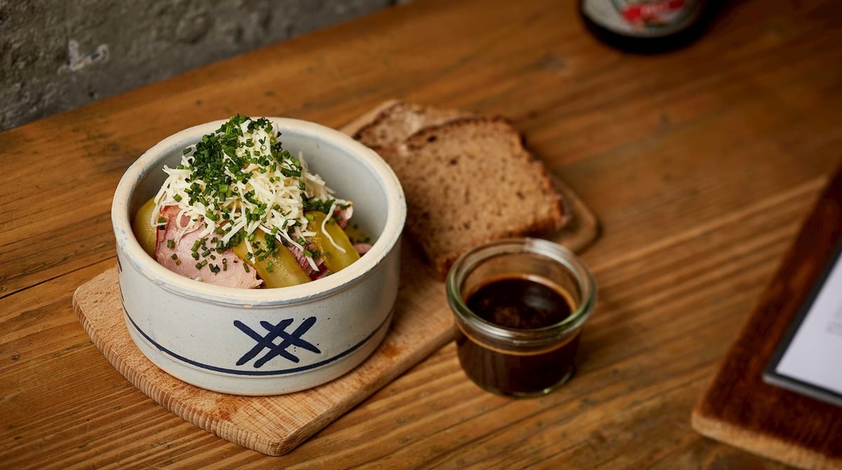 Brotzeit in der Steingutschüssel mit Sauerteigbrot und Soße