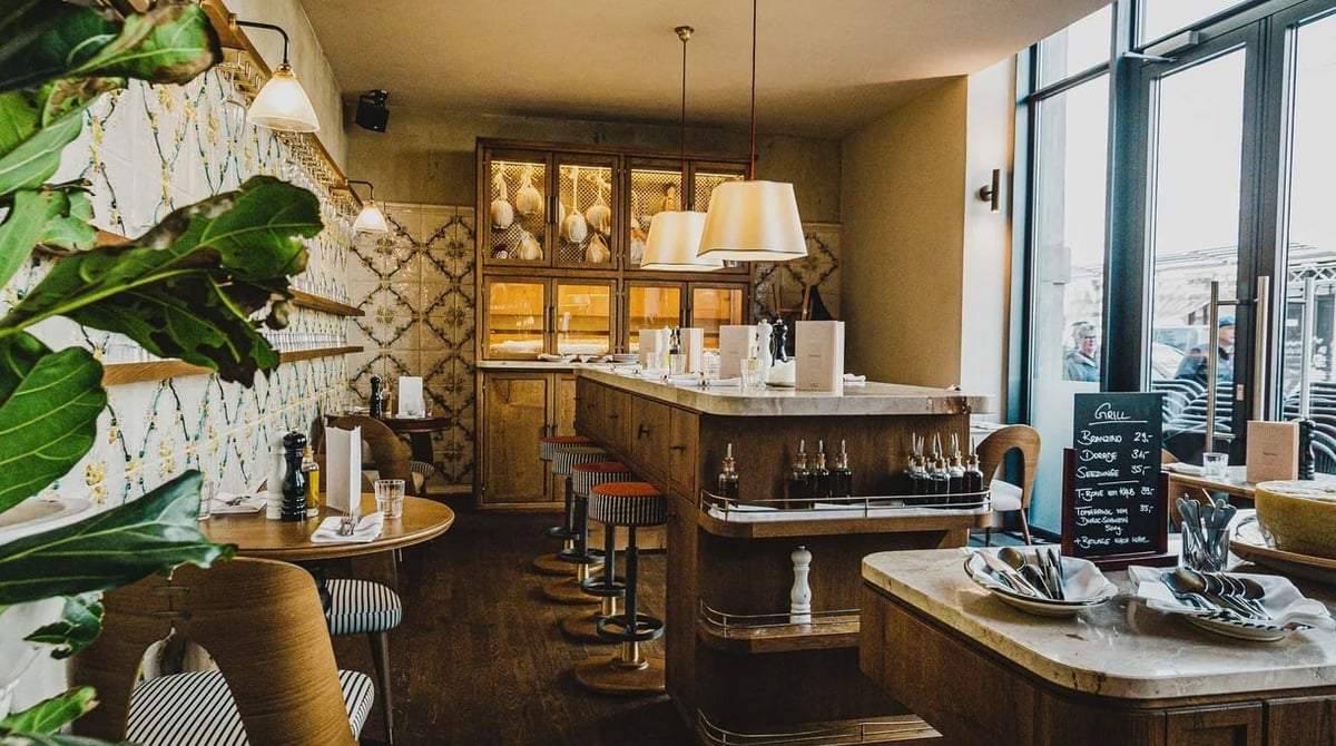 Die Cicchetteria der Gigi Trattoria mit gefliester Wand, Holzbar und Fensterfront