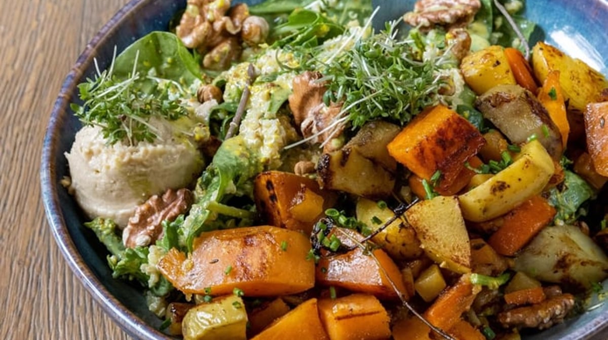 Bowl mit geröstetem Gemüse, Walnüssen und Hummus