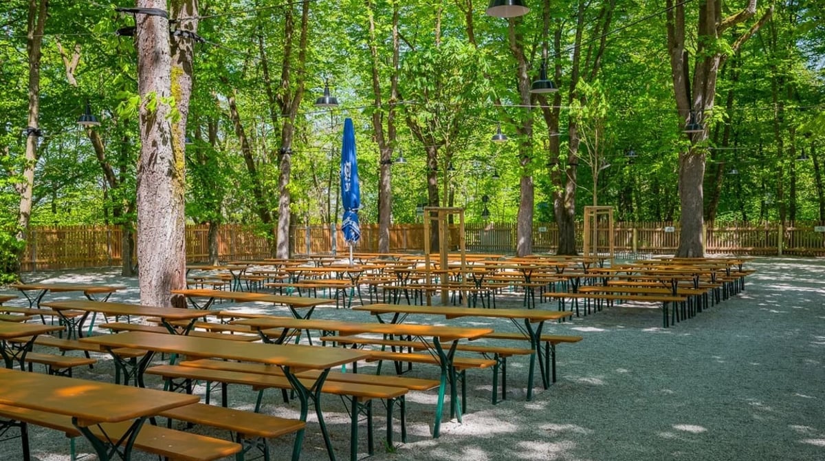 Bierbänke und Biertische im Kastanienhain des Biergartens