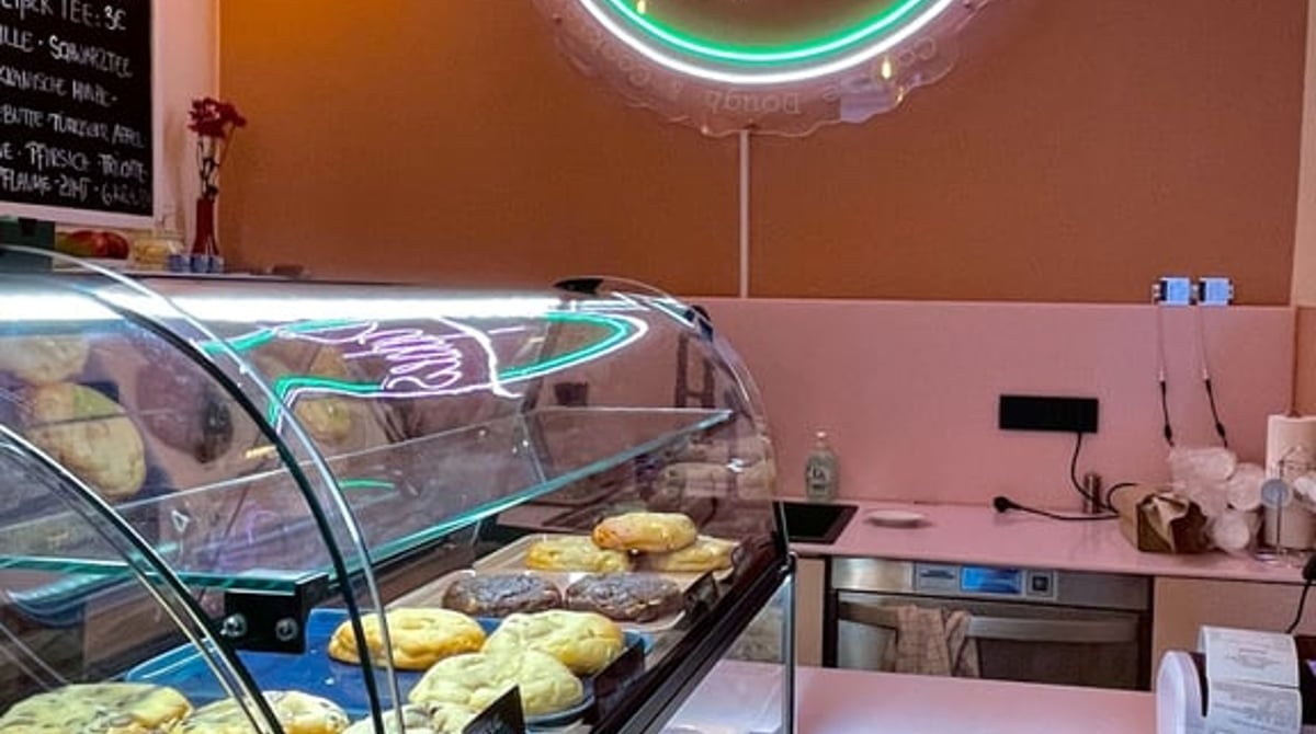 Theke mit Cookie-Vitrine unter dem Dapkies-Neonschild