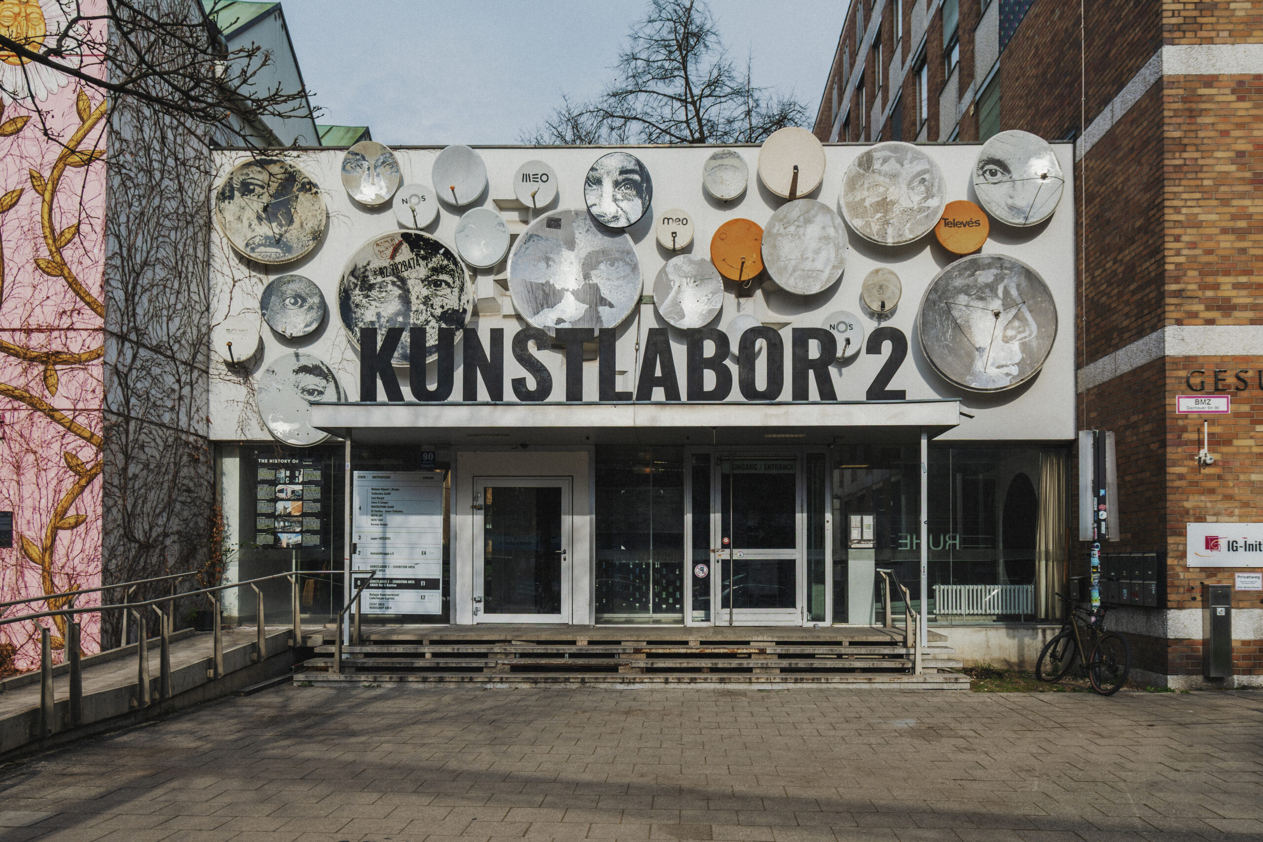 Facade of Kunstlabor 2 with a wall of metal discs forming an art installation above the entrance.