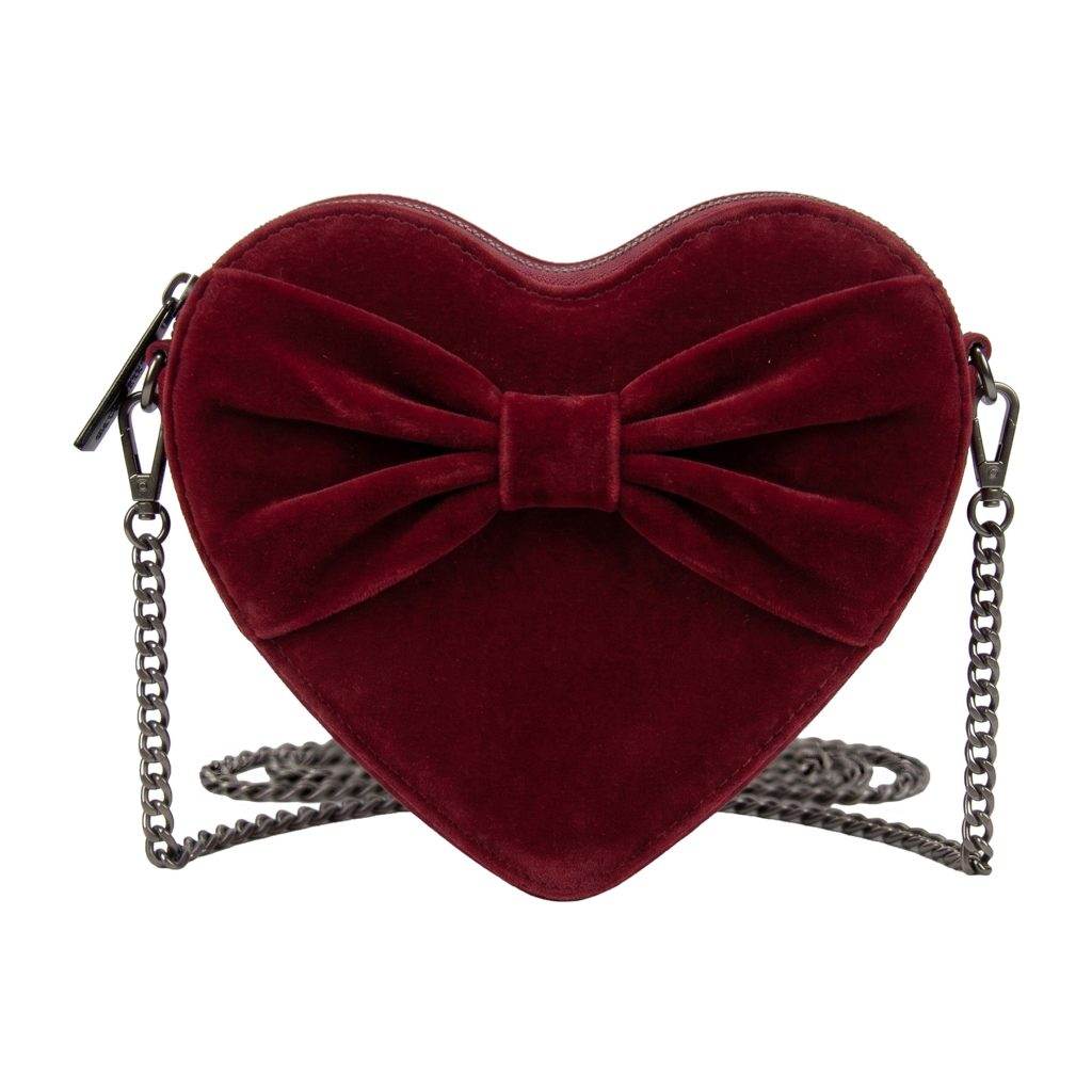Red velvet heart-shaped purse with a bow and a metal chain strap.