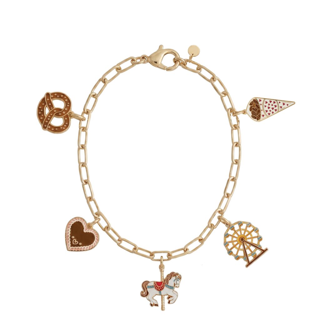 Gold chain charm bracelet with multiple enamel charms: a heart, a pretzel, a carousel horse, a ferris wheel, and an ice cream cone motif.