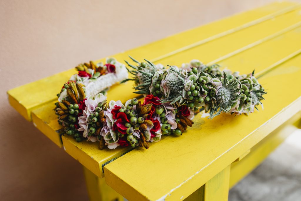 Colorful flower bouquet resting on bright yellow wooden steps.