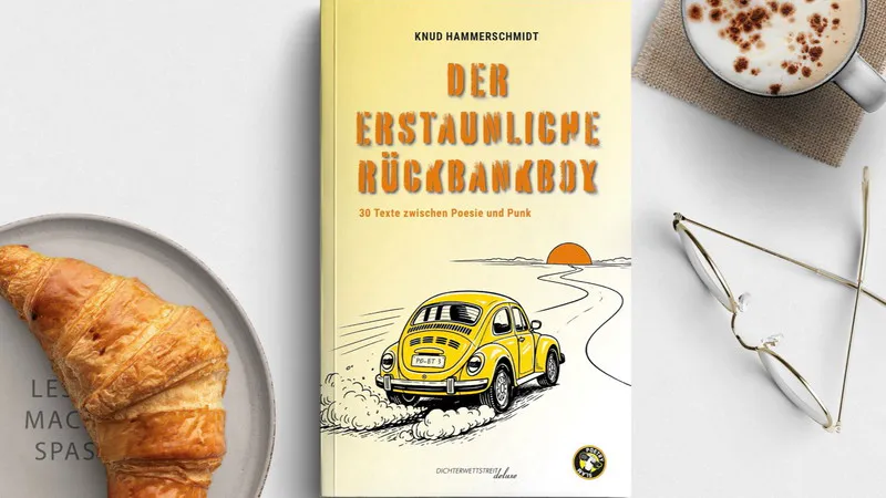 knud - IN München - Das Stadtmagazin Flat lay of a book with a bright yellow cover featuring a yellow vintage car, on a desk beside a croissant, a cup of coffee, and glasses.